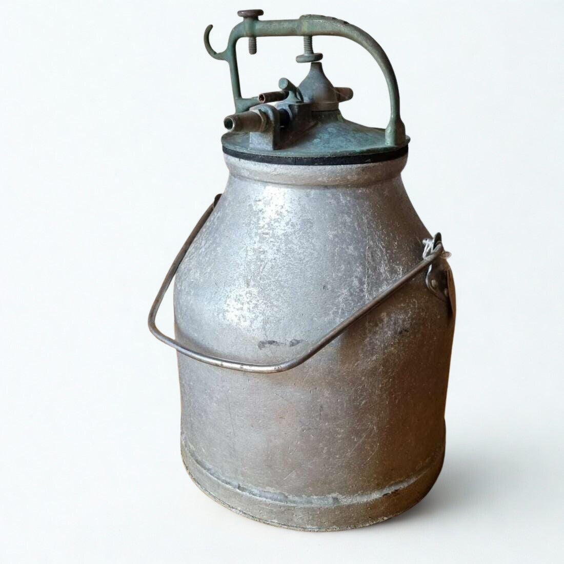 Vintage metal milk churn with a pump on a white background