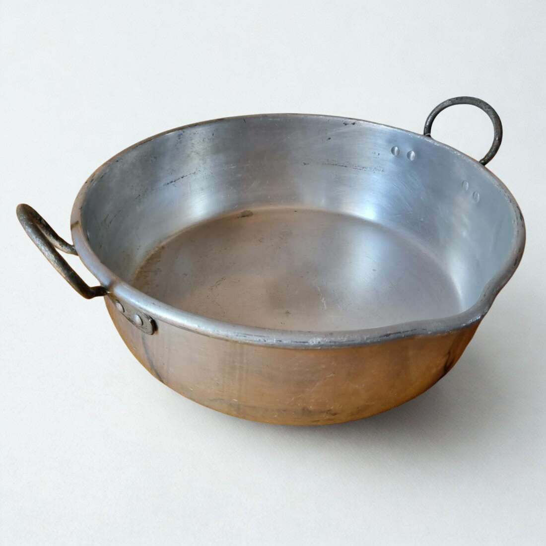 Metallic pot with handles on a white background