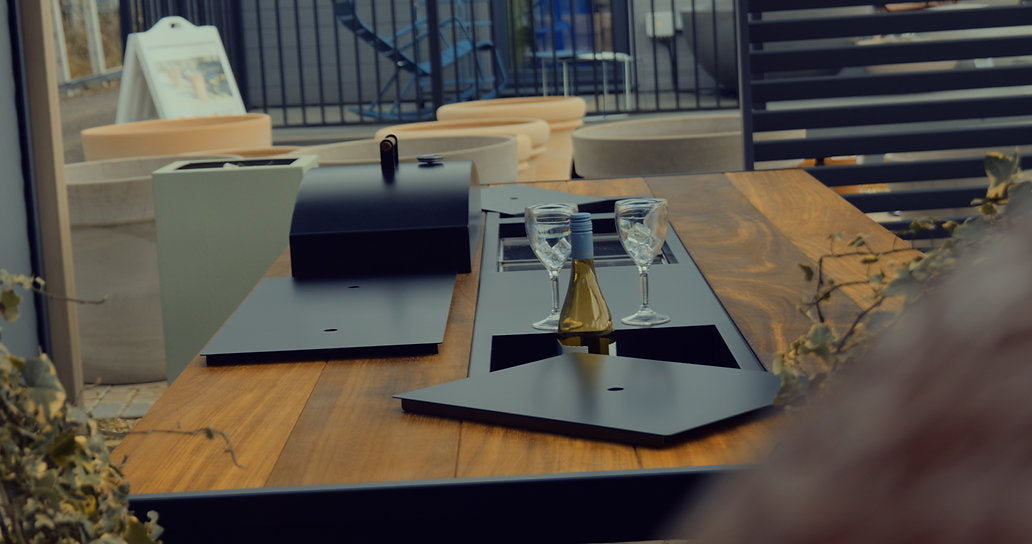 Tabletop gaming setup with dice and cards on a wooden table outdoors.