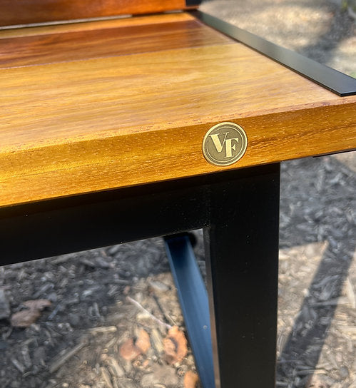 Wooden table with a visible brand logo on a textured surface