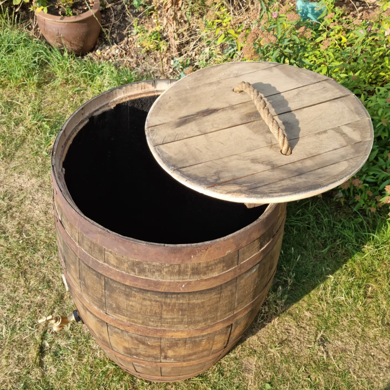 Wooden compost bin with a lid on grass