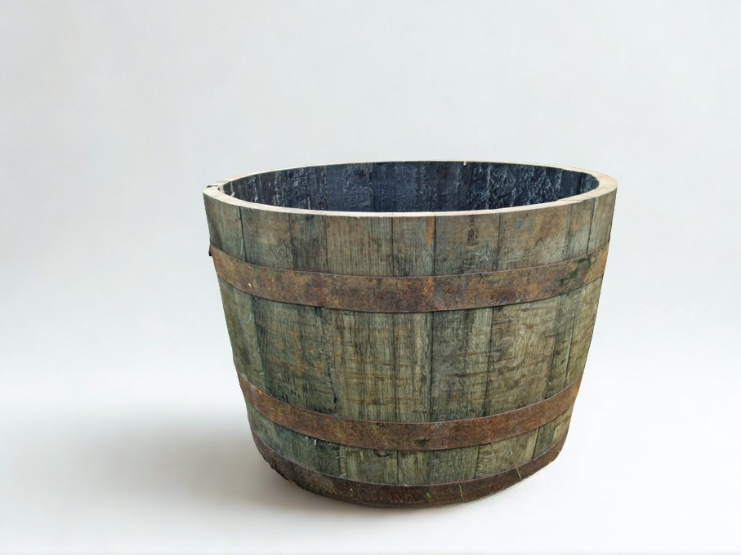 Wooden barrel planter on a white background