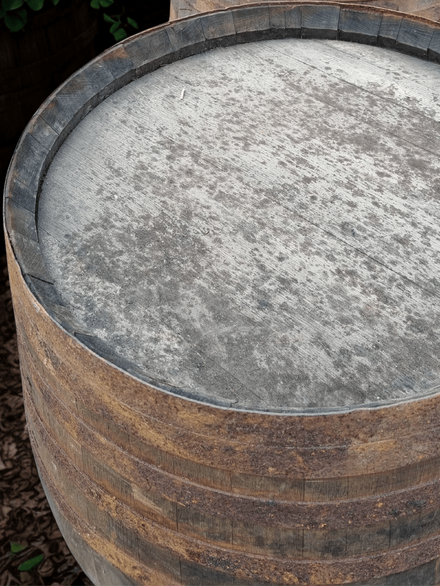 Close-up of a wooden barrel with a metal lid