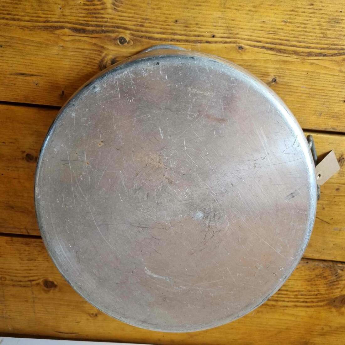 Round metal pan on a wooden surface