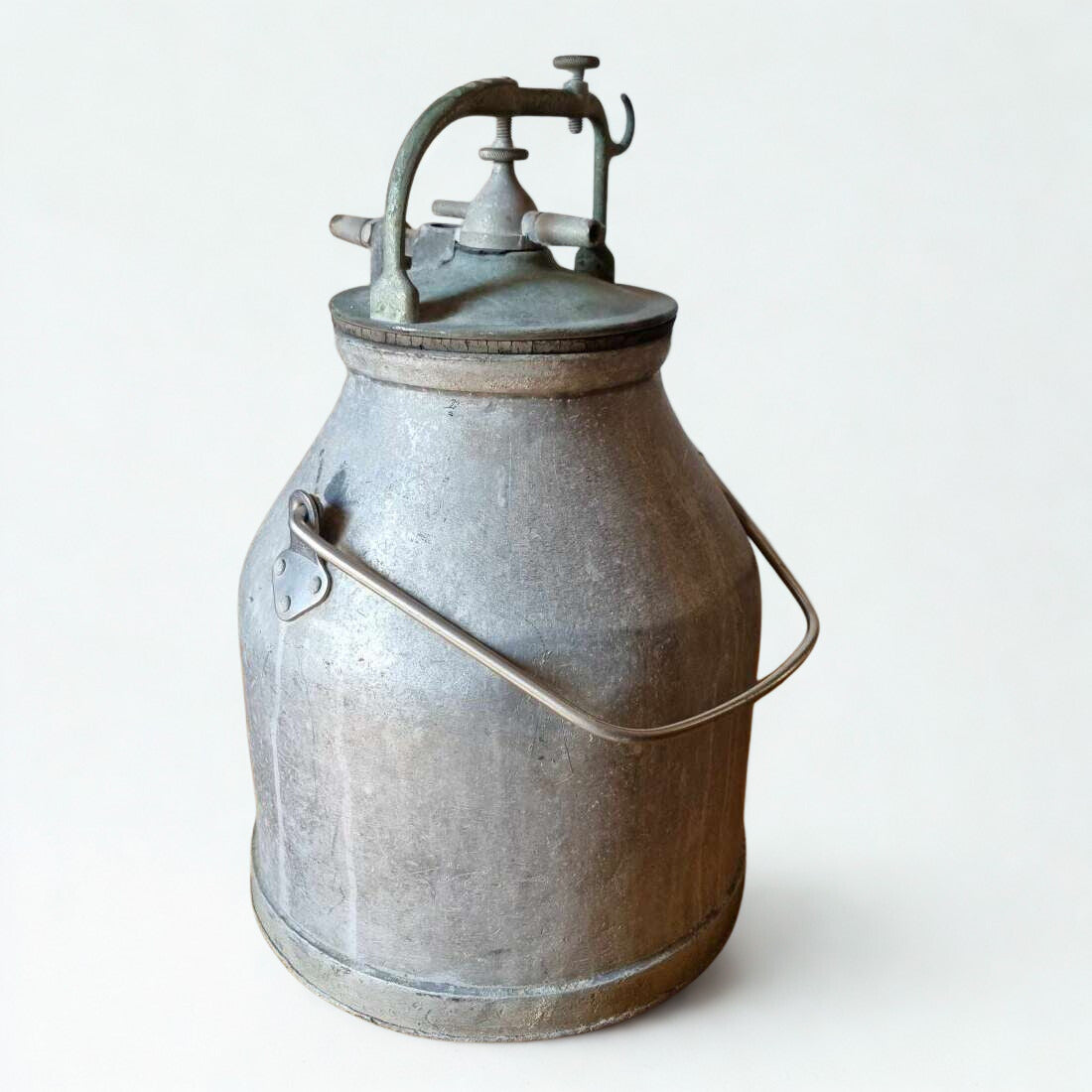 Vintage metal milk churn on a white background