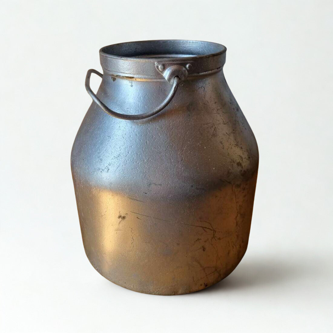 Metal milk churn with a handle on a white background