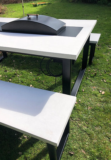 Outdoor table with benches on a grassy area